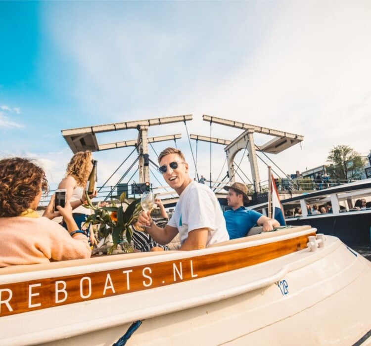 Guests enjoying drinks from an open bar on the ultimate Amsterdam canal cruis