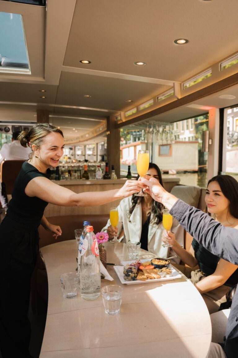 Server at Canal Boat handing guests a drink