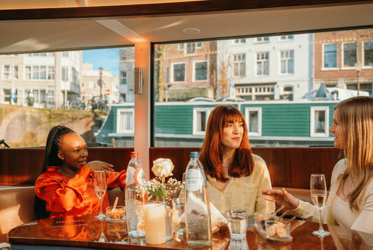 Guests seated on an elegant boat during a semi-private Amsterdam canal cruise