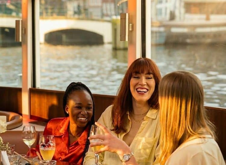 People relaxing on board the Stan Huygens canal boat in Amsterdam