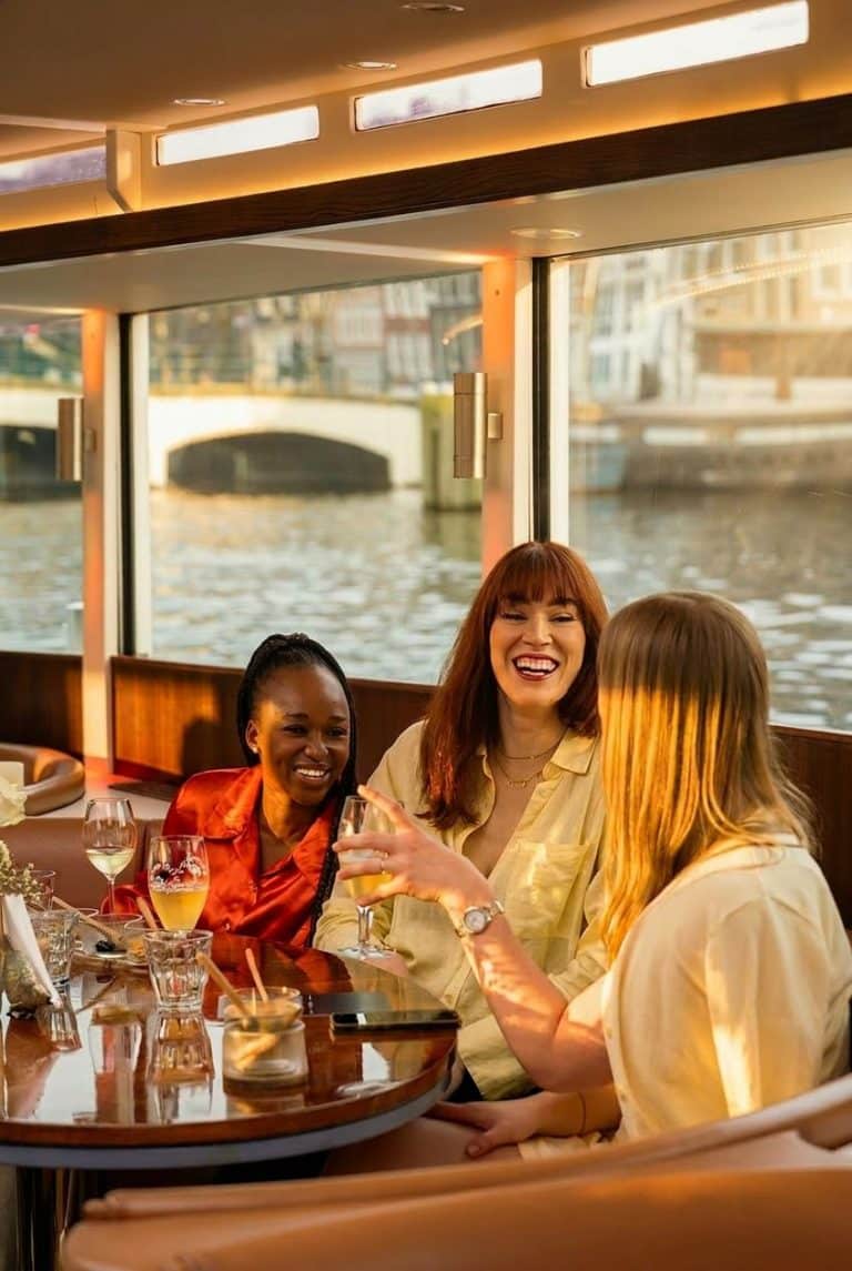 People relaxing on board the Stan Huygens canal boat in Amsterdam