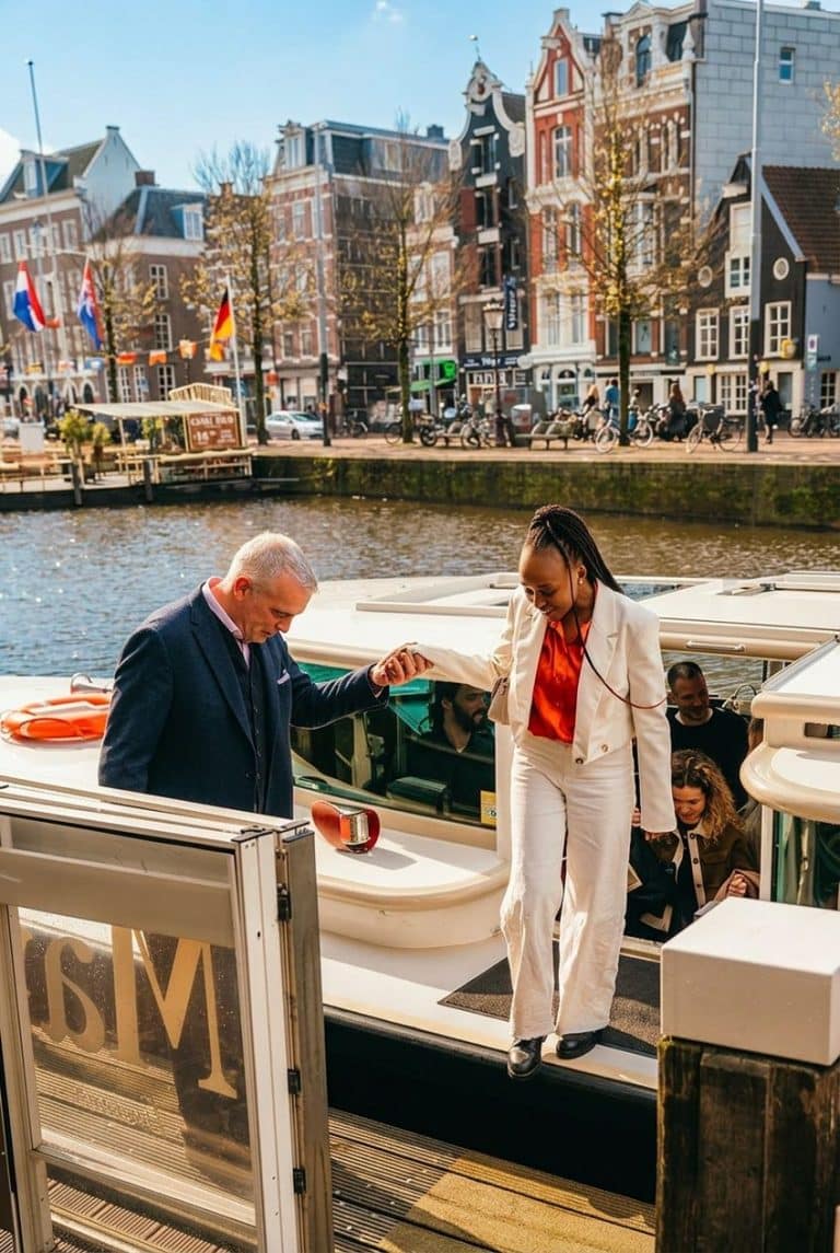 Guests off boarding from canal boat in Amsterdam